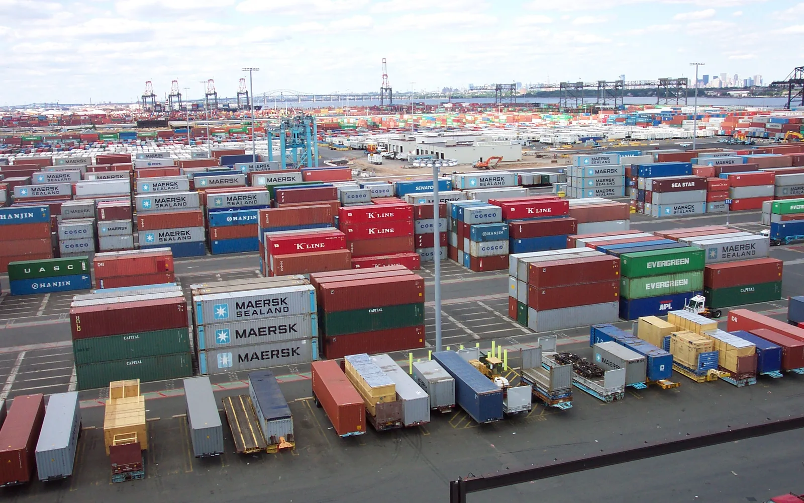 Stacked shipping containers at a port terminal loading facility